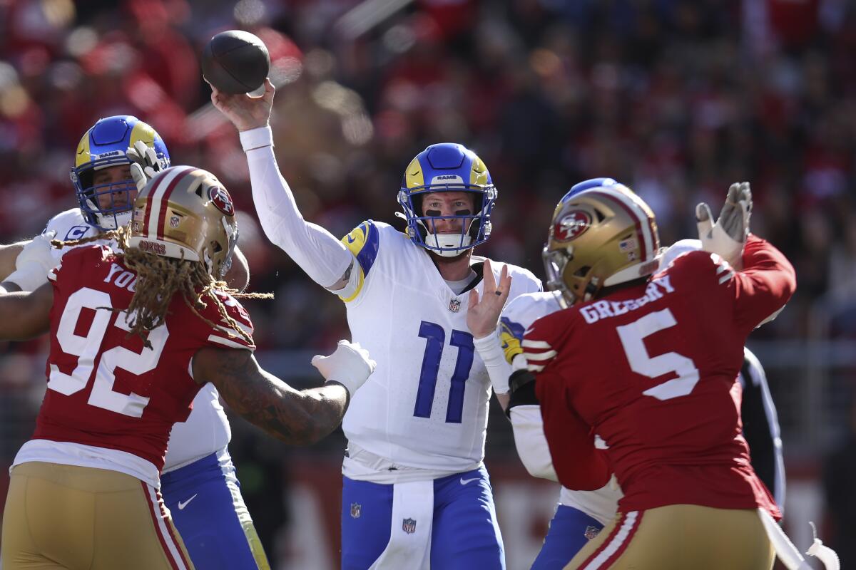 Rams quarterback Carson Wentz (11) passes against the San Francisco 49ers.