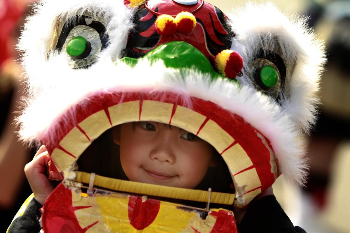 Vivian Chan, 5, wears a baby lion mask in the annual Golden Dragon Parade in 2011.