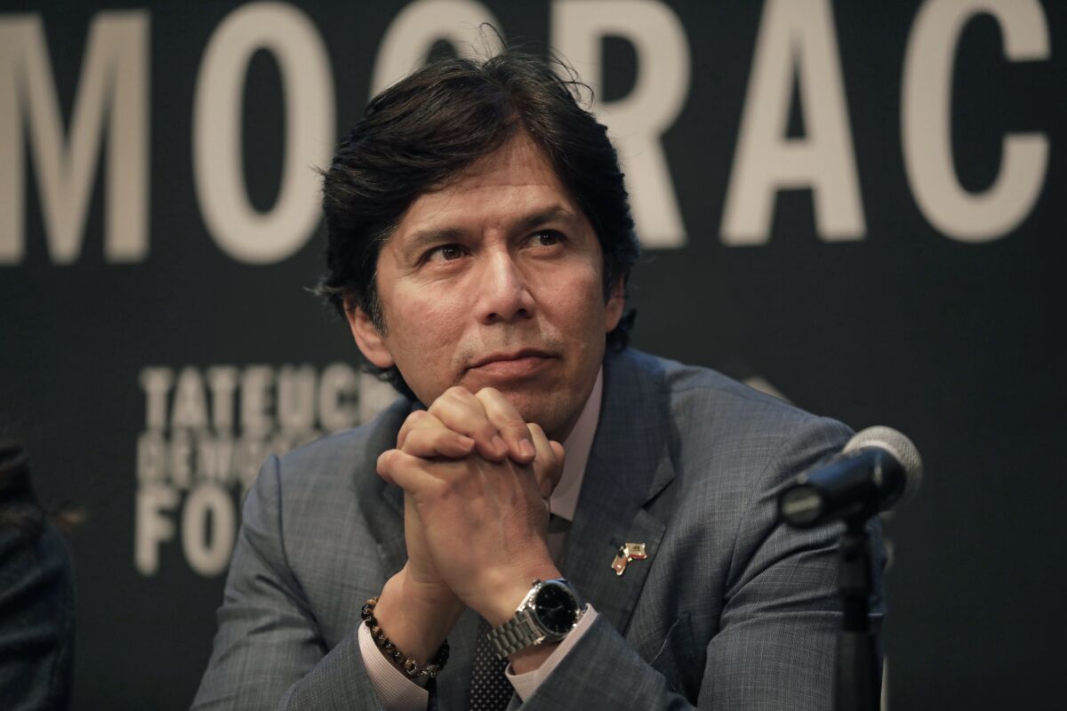 Kevin de Leon, seated behind a microphone, takes part in a forum in Little Tokyo in February.
