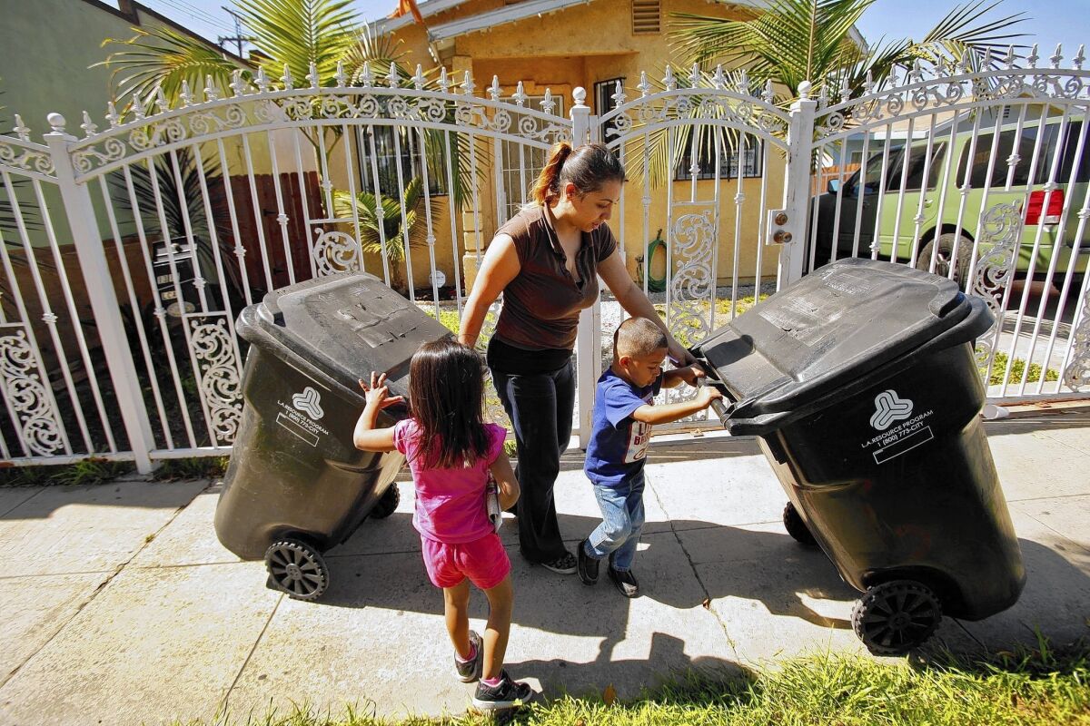 Crystal Garcia, 26, is concerned about the safety of her children -- Melonie, 4, left, and Jesse, 3 -- since elevated levels of lead have been found in the soil around her neighbors' homes in Boyle Heights, near the Exide Technologies plant in Vernon.