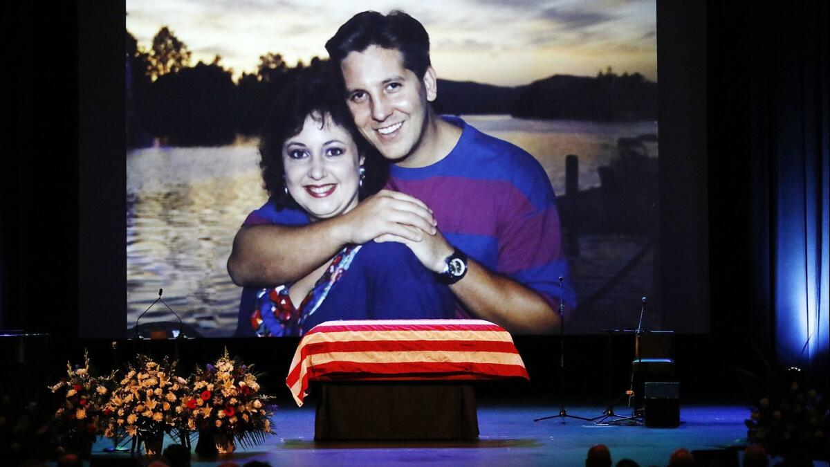 A family photo of slain Ventura County Sheriff's Sgt. Ron Helus with his wife, Karen, is shown during a memorial service for Helus.