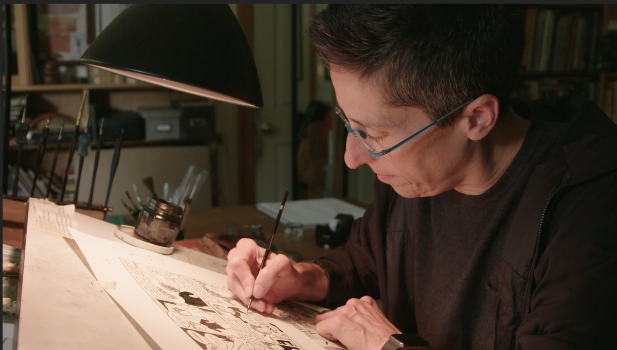 A woman working at a drawing table