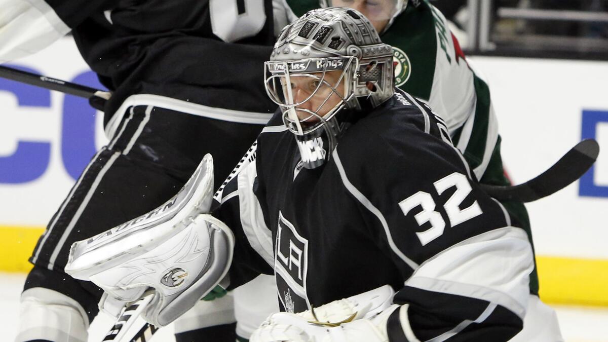 Kings goalie Jonathan Quick keeps his eyes on the puck during the third period of a 2-1 win over the Minnesota Wild on Sunday.