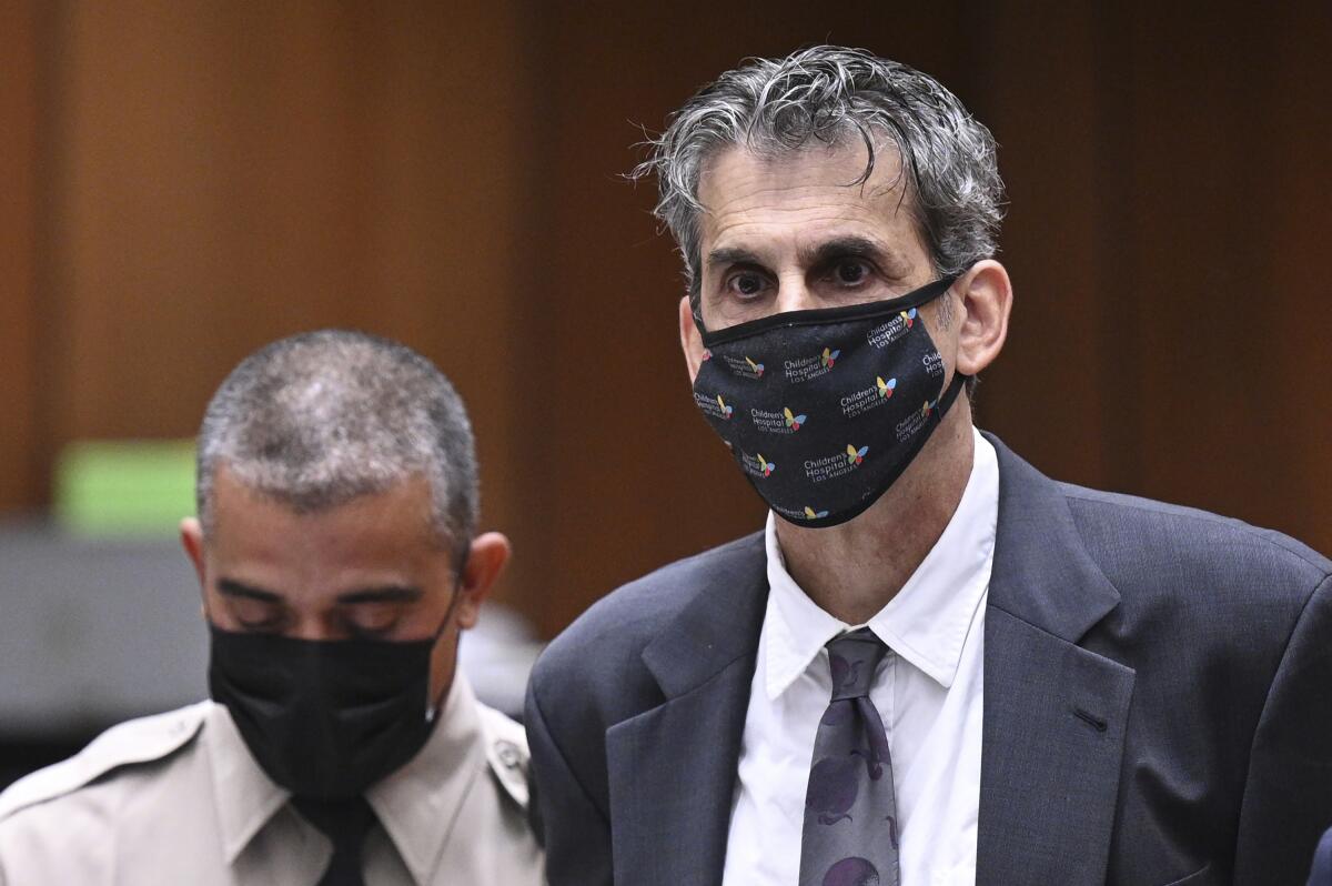 Producer Eric Weinberg, right, looks up after bail was denied at his arraignment Oct. 25 in Superior Court in Los Angeles.