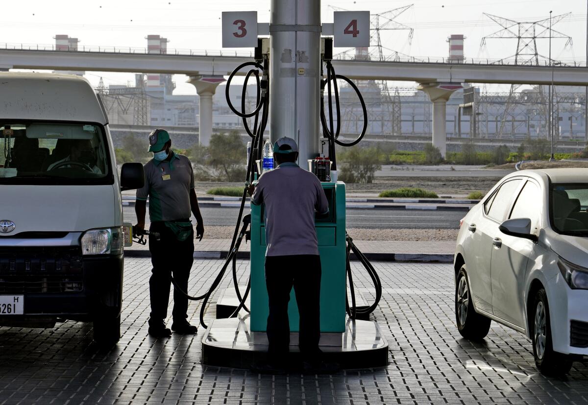 Gas station attendant filling a tank in Dubai