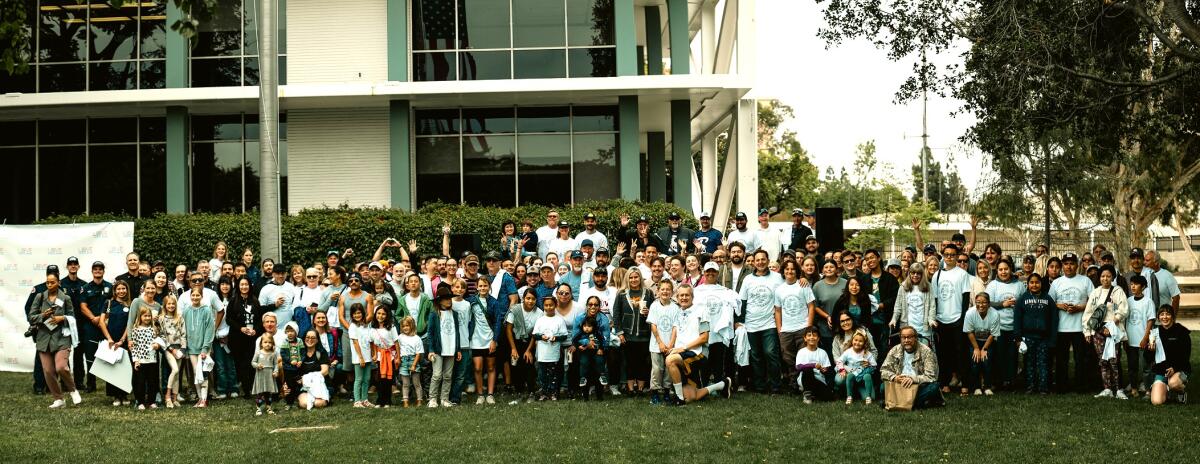 Volunteers gather outside Costa Mesa City Hall for a group photo during Love Costa Mesa's day of community service in 2024.