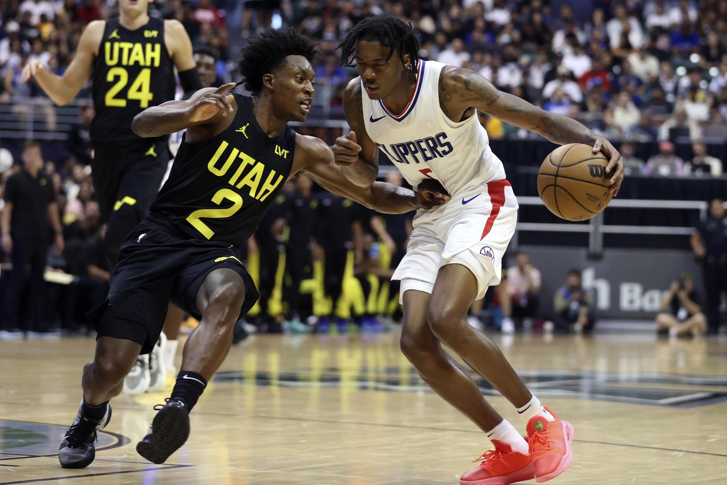 Clippers guard Bones Hyland, right, controls the ball in front of Utah Jazz guard Collin Sexton.