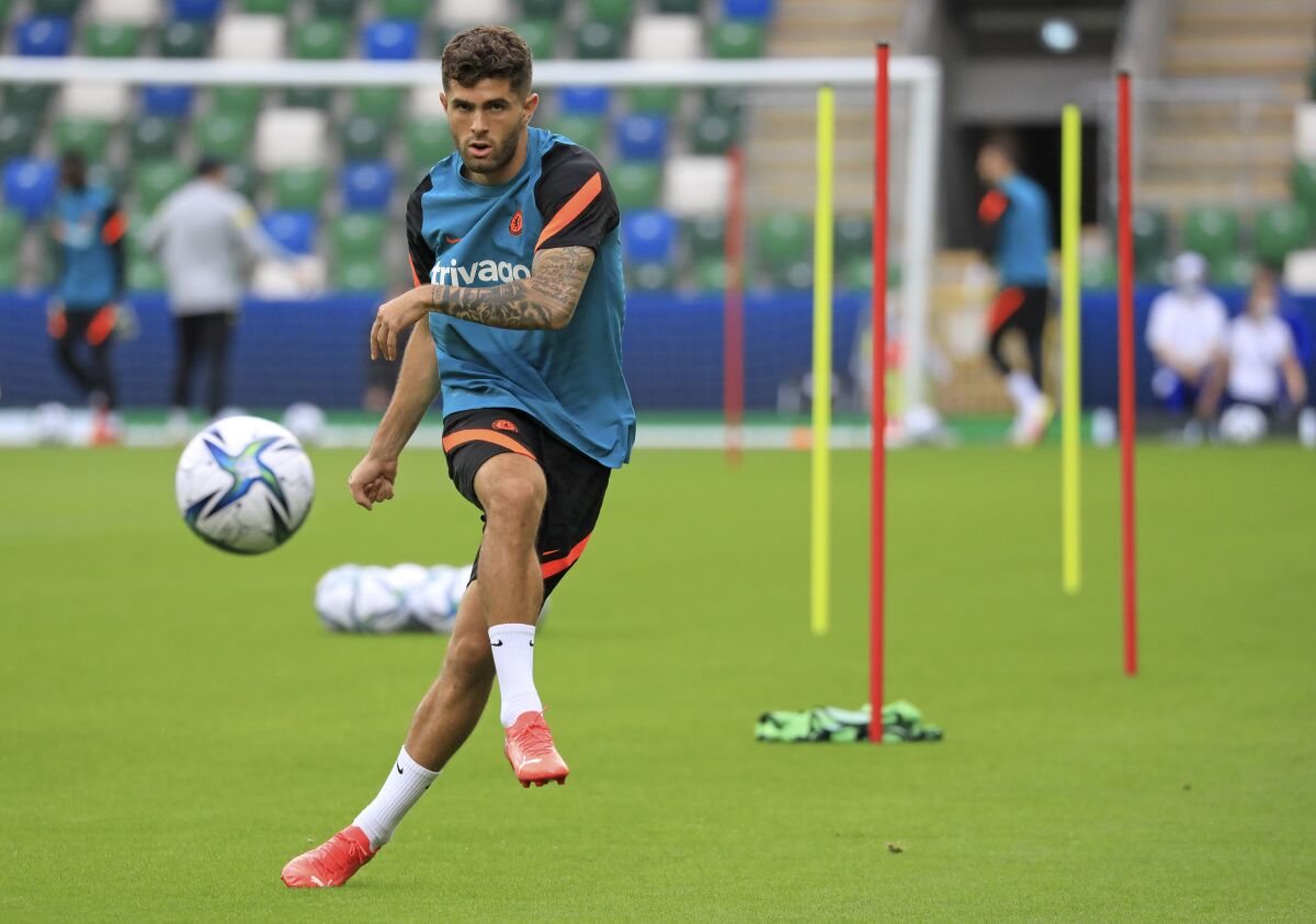 FILE - In this Aug. 10, 2021 file photo, Chelsea's Christian Pulisic kicks the ball during a training session at Windsor Park in Belfast, Northern Ireland. Chelsea says Christian Pulisic has resumed training ahead of Saturday's match at winless Newcastle. The 23-year-old Pulisic has not featured since Aug. 14 when he scored in Chelsea’s 3-0 win over Crystal Palace to open the league season. (AP Photo/Peter Morrison)