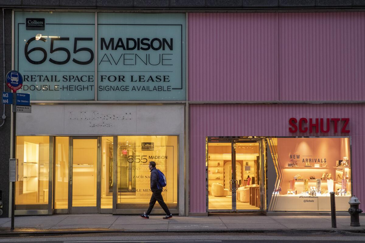 A pedestrian walks past a storefront for rent on Madison Avenue in New York on March 19.