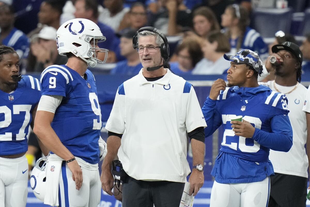 FILE - Indianapolis Colts head coach Frank Reich talks with quarterback Nick Foles (9) in the first half of an NFL preseason football game against the Tampa Bay Buccaneers in Indianapolis, Saturday, Aug. 27, 2022. The Colts know they must get off to a faster start than they have recently. Their eight straight opening-day losses is the longest active streak in the league. And after missing the playoffs following a 1-5 start in 2021, coach Frank Reich changed the training camp schedule in hopes of a change.(AP Photo/AJ Mast, File)