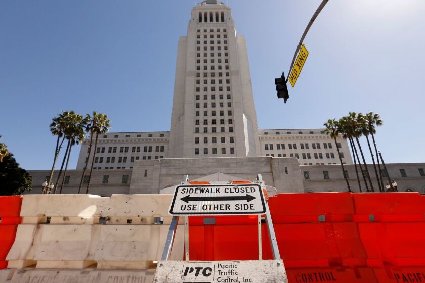 LOS ANGELES, CA - MARCH 6, 2017 - Barricades halt pedestrian traffic as a film crew works on the steps of Los Angeles City Hall in downtown Los Angeles as the film "Ocean's Eight" is shooting scenes on the Spring Street steps March 6, 2017. The film features female thieves who try to pull off the heist of the century at New York's annual Met Gala. (Al Seib / Los Angeles Times)
