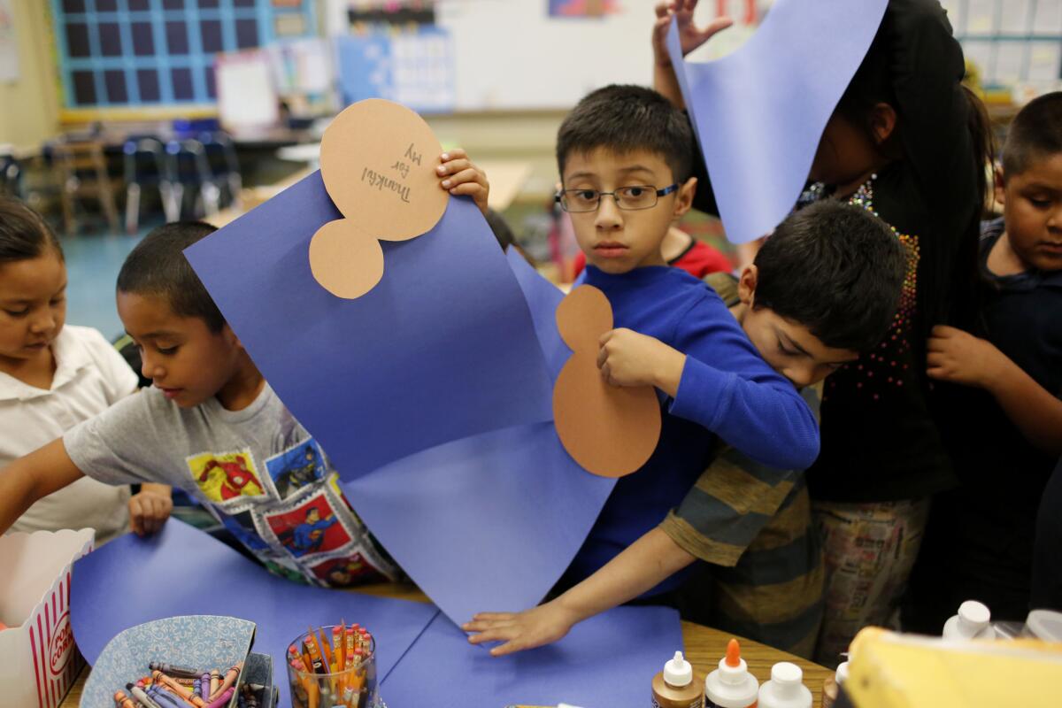 Second-graders at Ann Street Elementary School gather materials during an arts-and-crafts class, which is part of LA's Best after-school program.