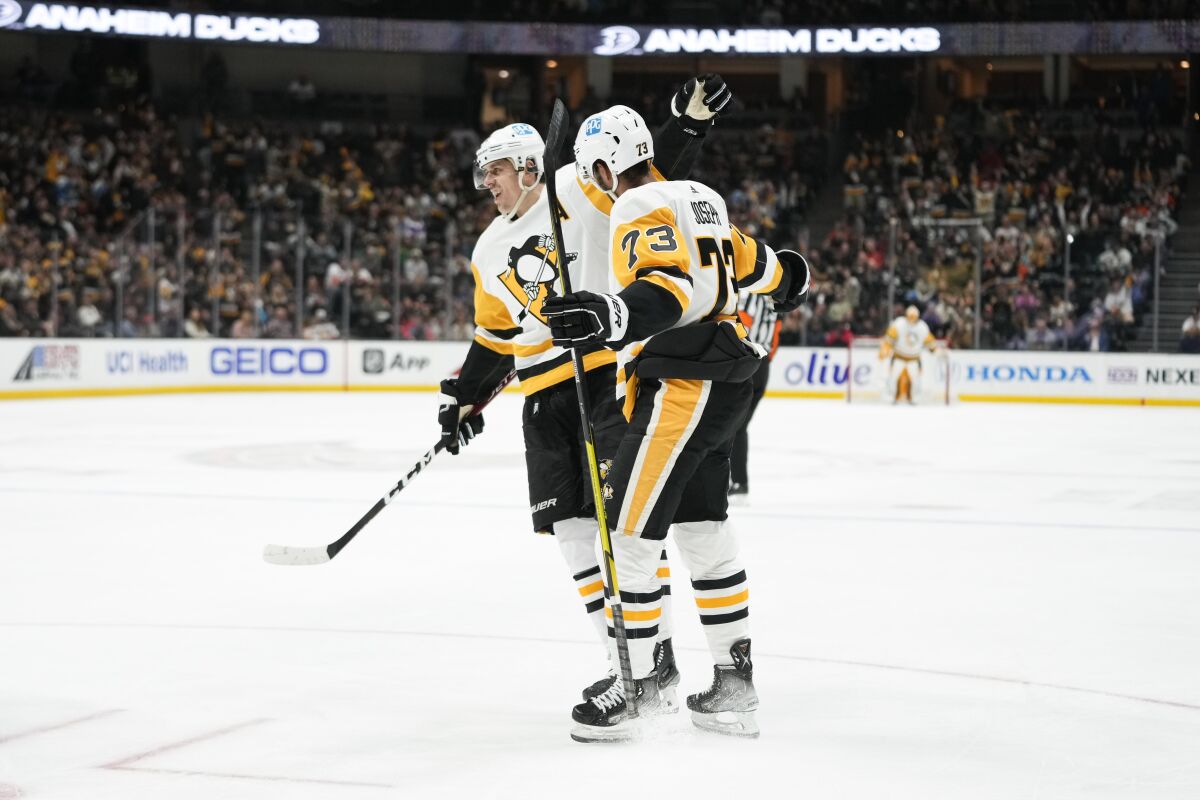 Pittsburgh's Pierre-Olivier Joseph (73) is greeted by Evgeni Malkin after Joseph scored in the second period Feb. 10, 2023.