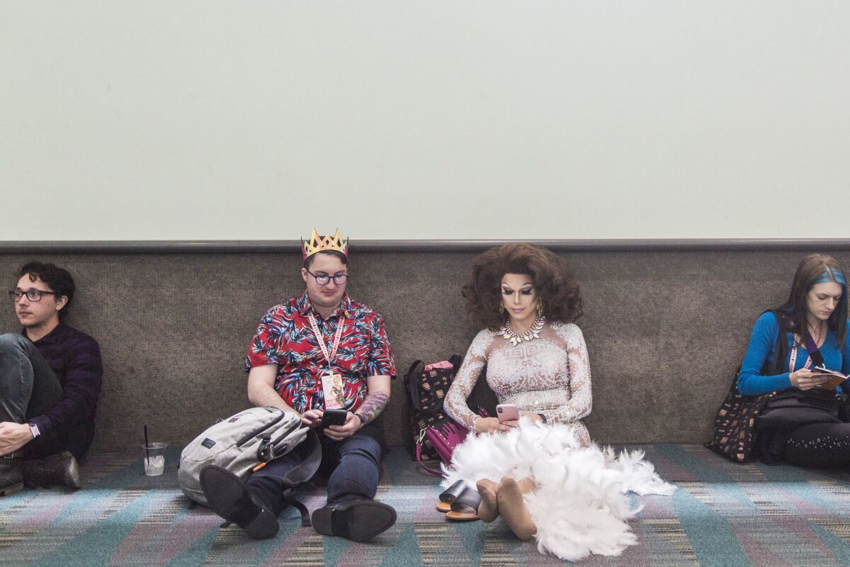 Patrick Patterson, left, and Anne Dromeda relax during RuPaul's DragCon LA at the Los Angeles Convention Center.