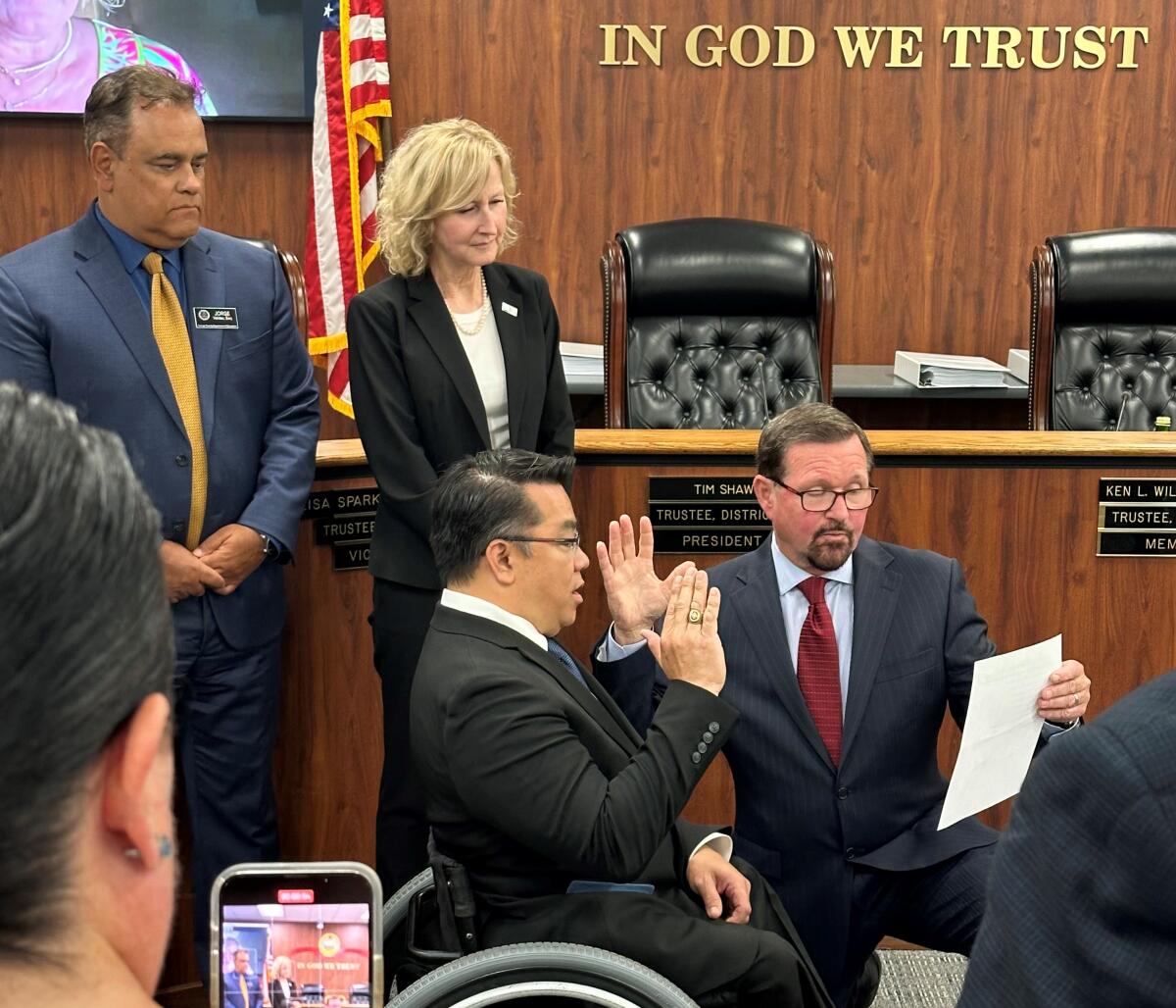 Garden Grove educator Dr. Stefan Bean cites the oath of office Tuesday at an Orange County Board of Education meeting. 