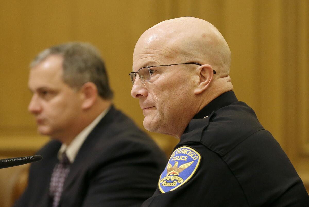 San Francisco Police Chief Greg Suhr, right, listens to public speakers during a meeting of San Francisco's Police Commission in San Francisco on Wednesday, Dec. 9, 2015.