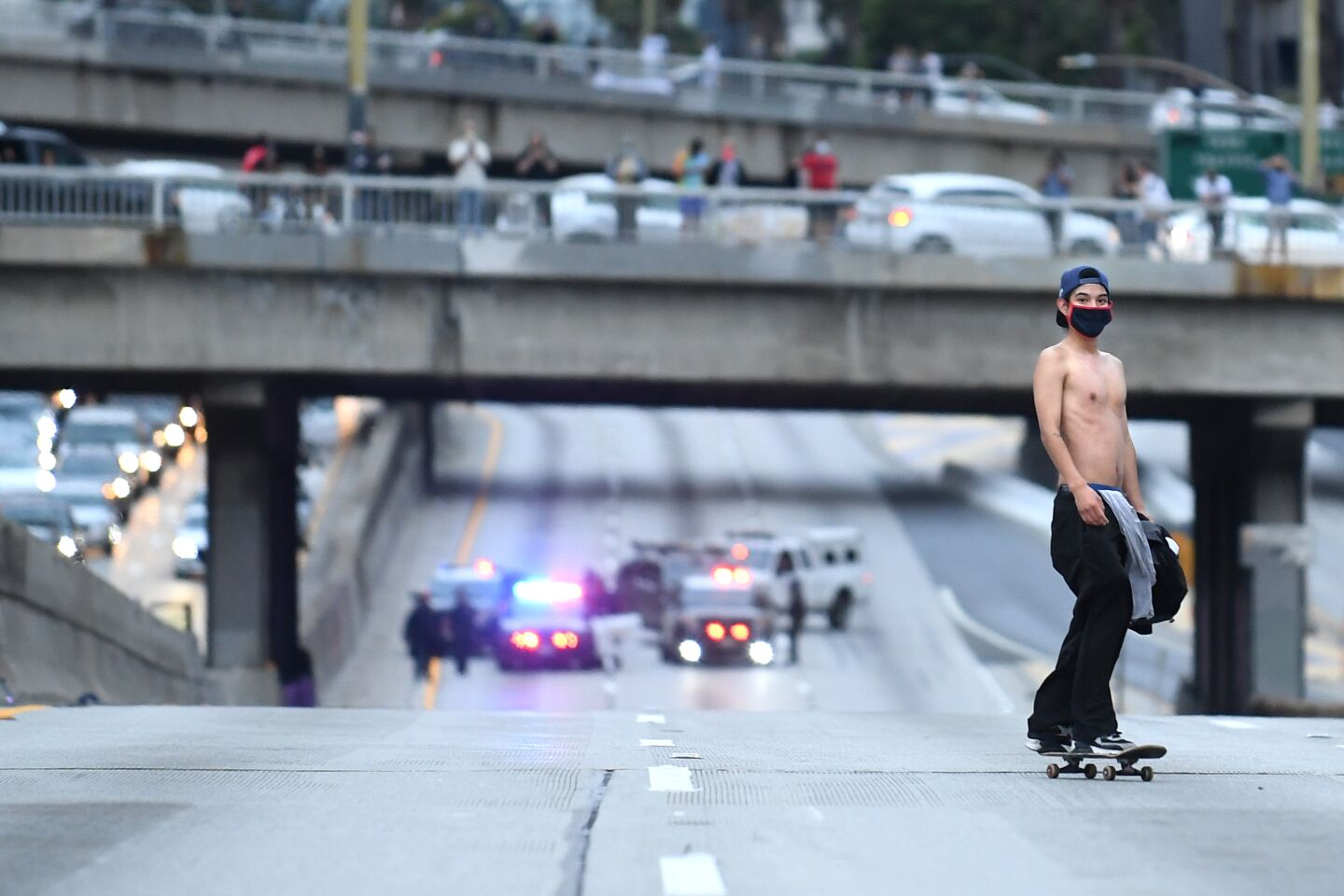 A protester rides a skateboard on the 110 Freeway.