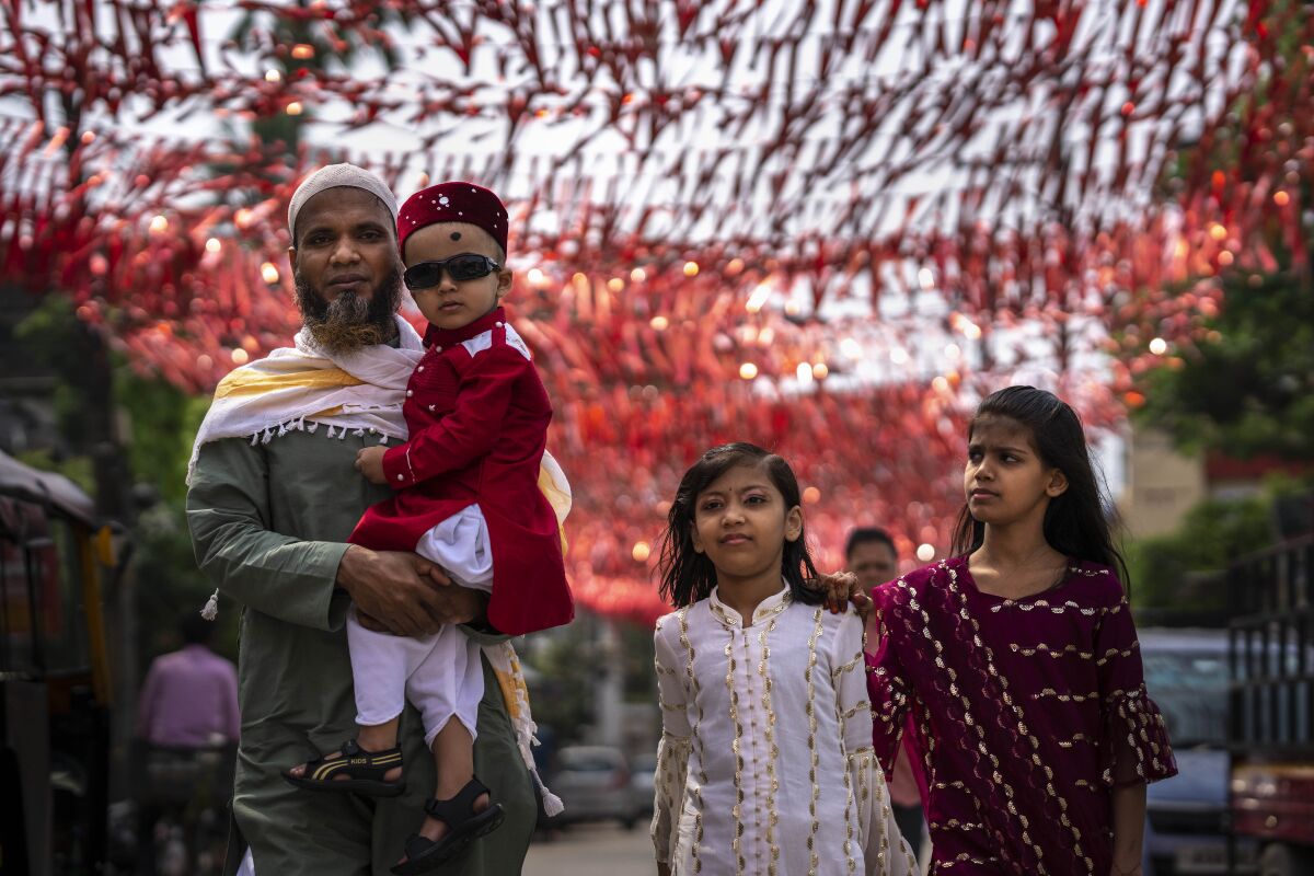 A Muslim family comes to offer Eid al-Fitr prayers in Gauhati, India, Tuesday, May 3, 2022. Eid al-Fitr marks the end of the fasting month of Ramadan. (AP Photo/Anupam Nath)
