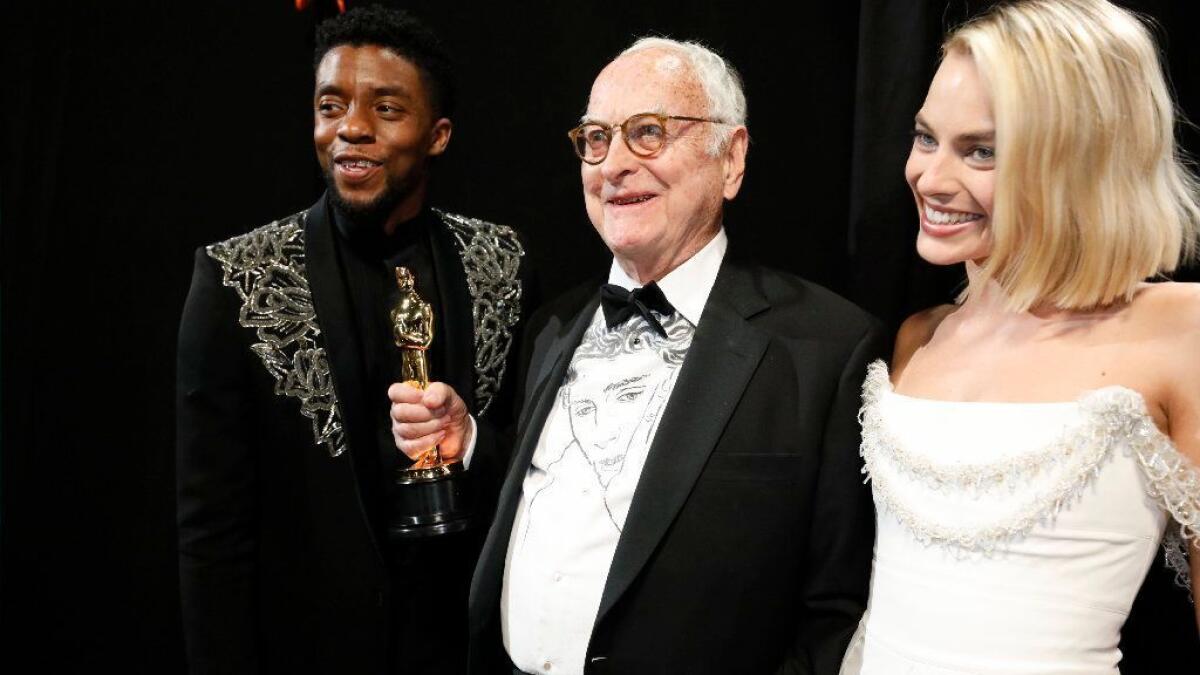 Academy Award winning writer James Ivory with presenters Chadwick Boseman and Margot Robbie.