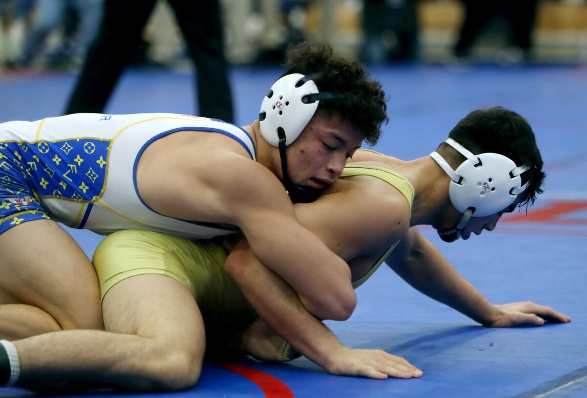 Fountain Valley High 160-pounder Max Wilner, left, pictured competing against Bellflower St. John Bosco's Louis Rojas on Feb. 16, advanced to the CIF State wrestling quarterfinals in Bakersfield Thursday.