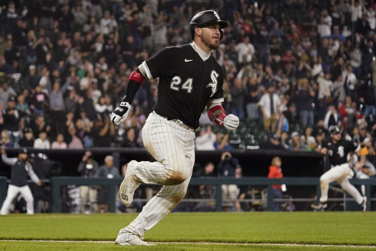 Chicago White Sox's Yasmani Grandal runs after hitting a two-run double during the eighth inning of a baseball game against the Texas Rangers in Chicago, Friday, June 10, 2022. (AP Photo/Nam Y. Huh)