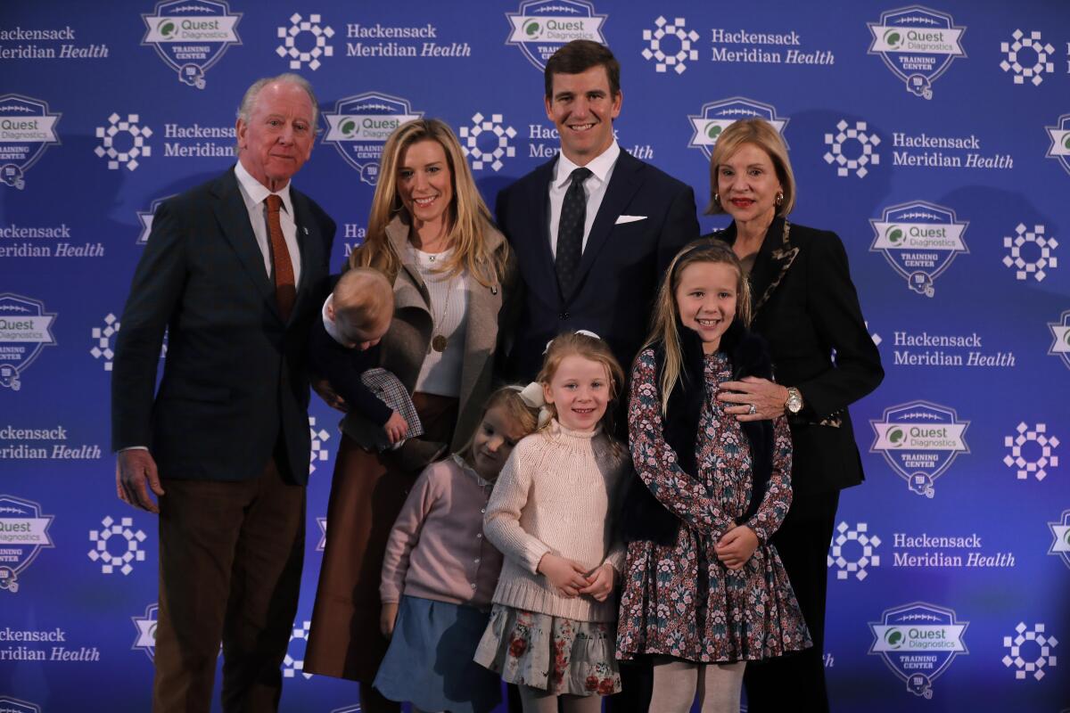 Eli Manning, center, poses with with his family and parents after announcing his retirement from the NFL in January.