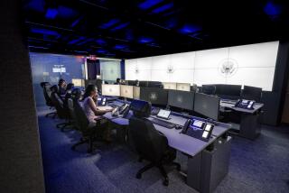 In this image provided by the White House, people sit at desks on the "watch floor," a 24-7 operations center, in the newly renovated complex of the White House Situation Room on Aug. 16, 2023, in Washington. The 5,500-square-foot, highly secure complex of conference rooms and offices in the West Wing has undergone a gut renovation that took a year to complete. (Carlos Fyfe/The White House via AP)