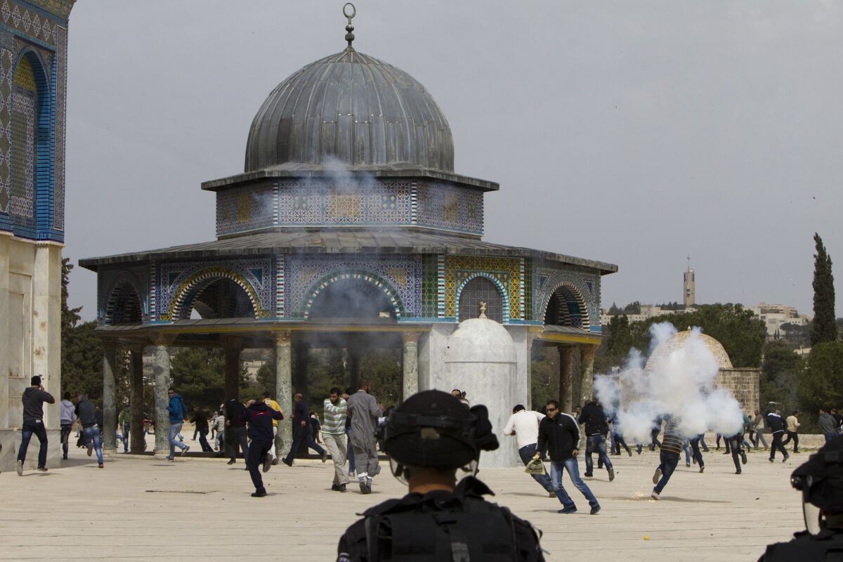 Israeli riot police clash with Palestinian demonstrators at Jerusalem's Al Aqsa Mosque compound following Friday prayers.