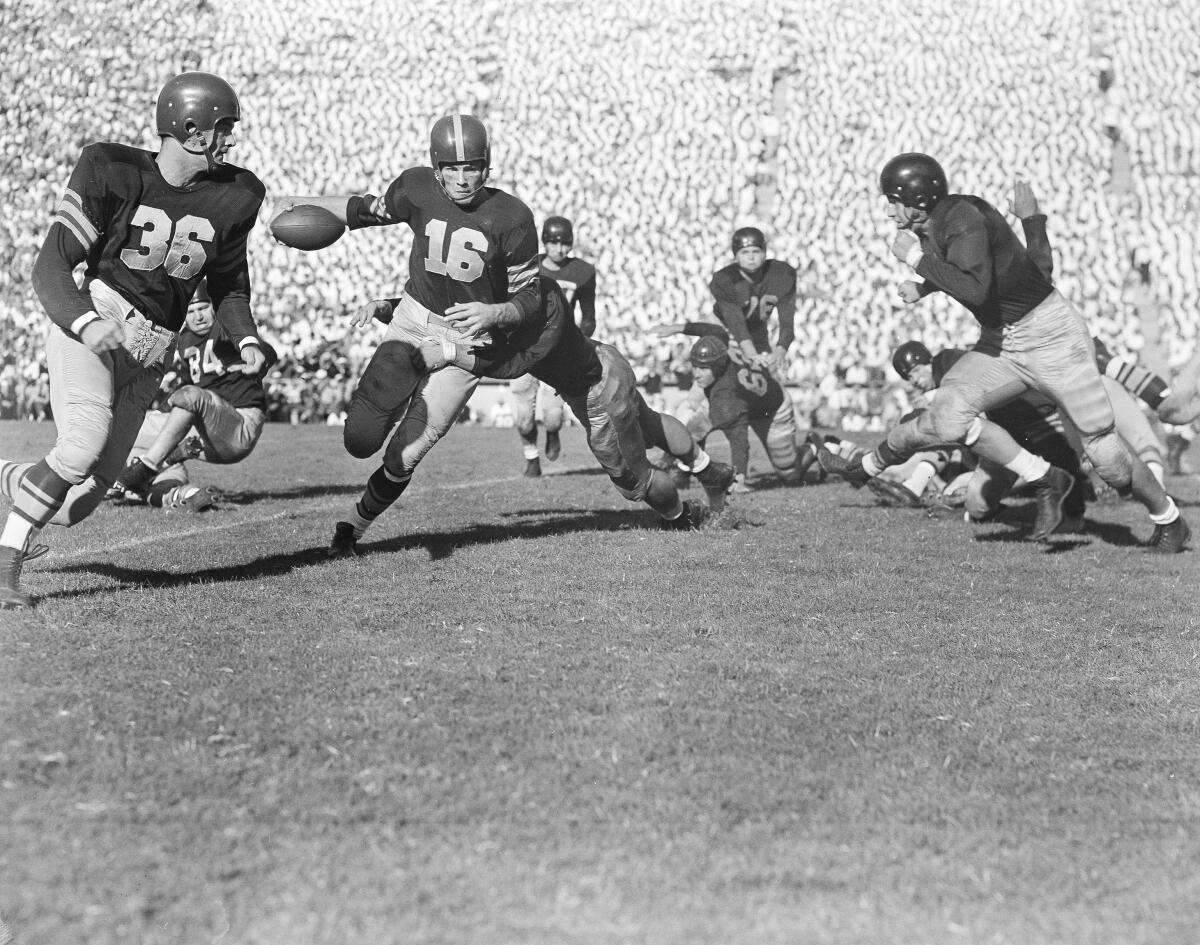 USC halfback Frank Gifford is about to be brought down by California's Les Richter after a short gain in 1951