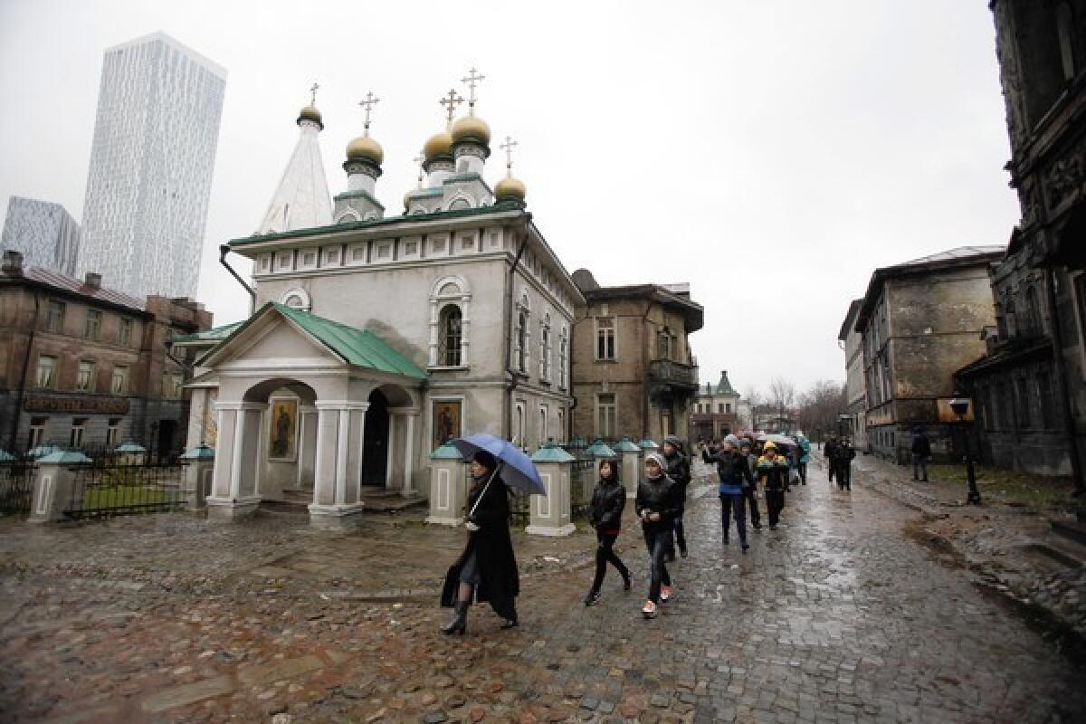 Schoolchildren walk past the old Moscow movie-set scenery as part of the tour of the Mosfilm Studios in downtown Moscow.