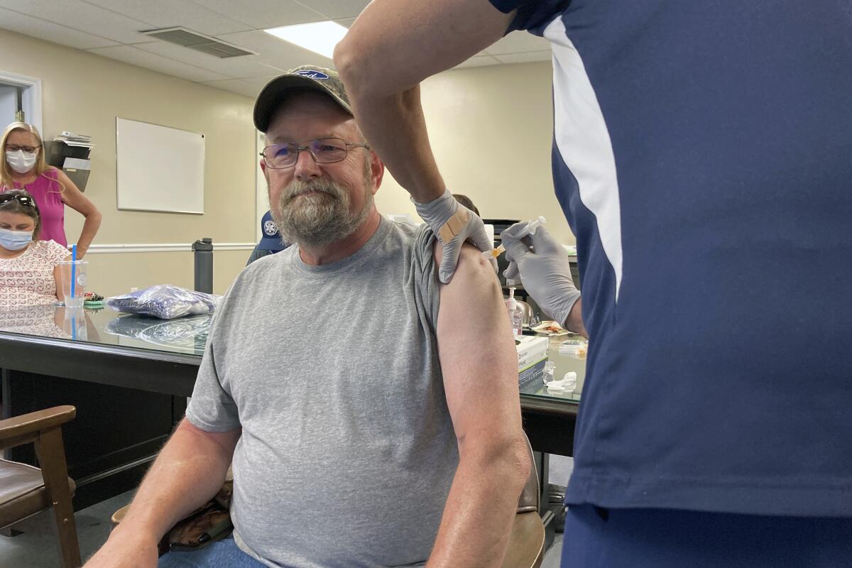 John Rogers receives a second dose of the COVID-19 vaccine in Taylorsville, Ky., on Thursday, June 17, 2021. Rogers waited months after becoming eligible for the COVID-19 vaccine. It was only after talking with friends that the retiree was persuaded to get the shot. “They said, ‘You know, the vaccine may not be 100%, but if you get COVID, you’re in bad shape,'" Rogers said. “You can die from it." (AP Photo/Dylan Lovan)