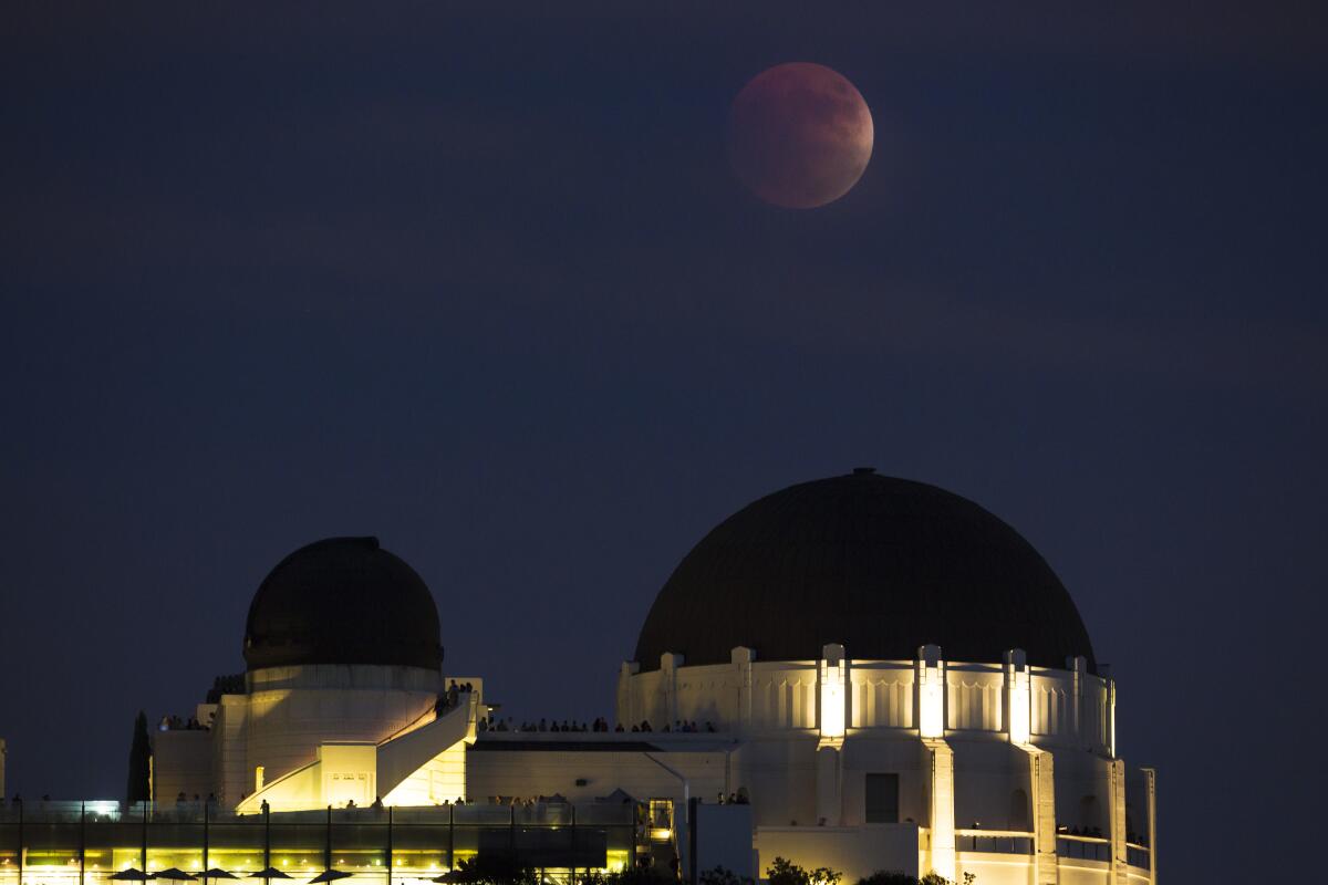 A super blood moon rises over the Griffith Park Observatory in L.A. 