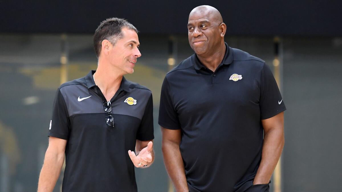 Lakers general manager Rob Pelinka speaks to Magic Johnson before a news conference in September 2018. The public nature of the Lakers' feuds has exacerbated their internal problems.