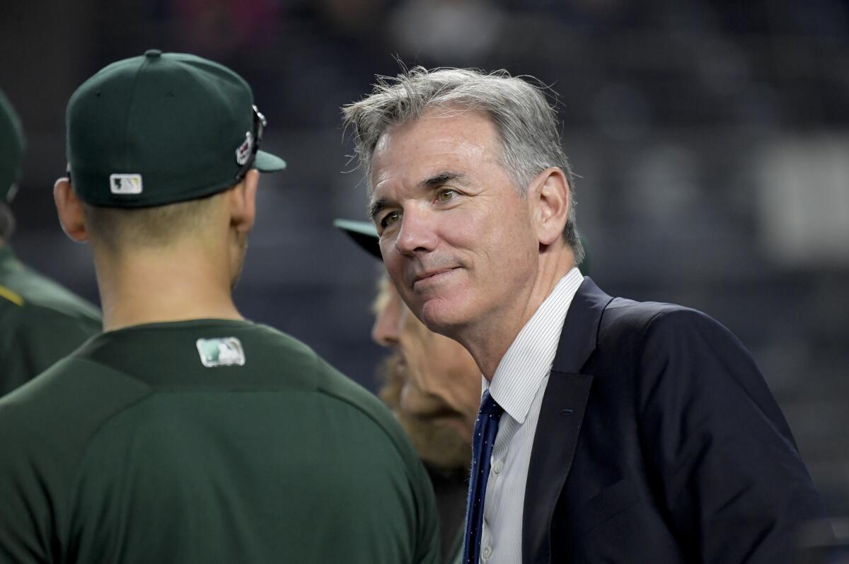 Oakland Athletics executive vice president Billy Beane talks with players.