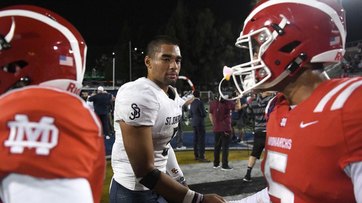 St. John Bosco quarterback DJ Uiagalelei shakes hands with Mater Dei players after a Trinity League victory last season.