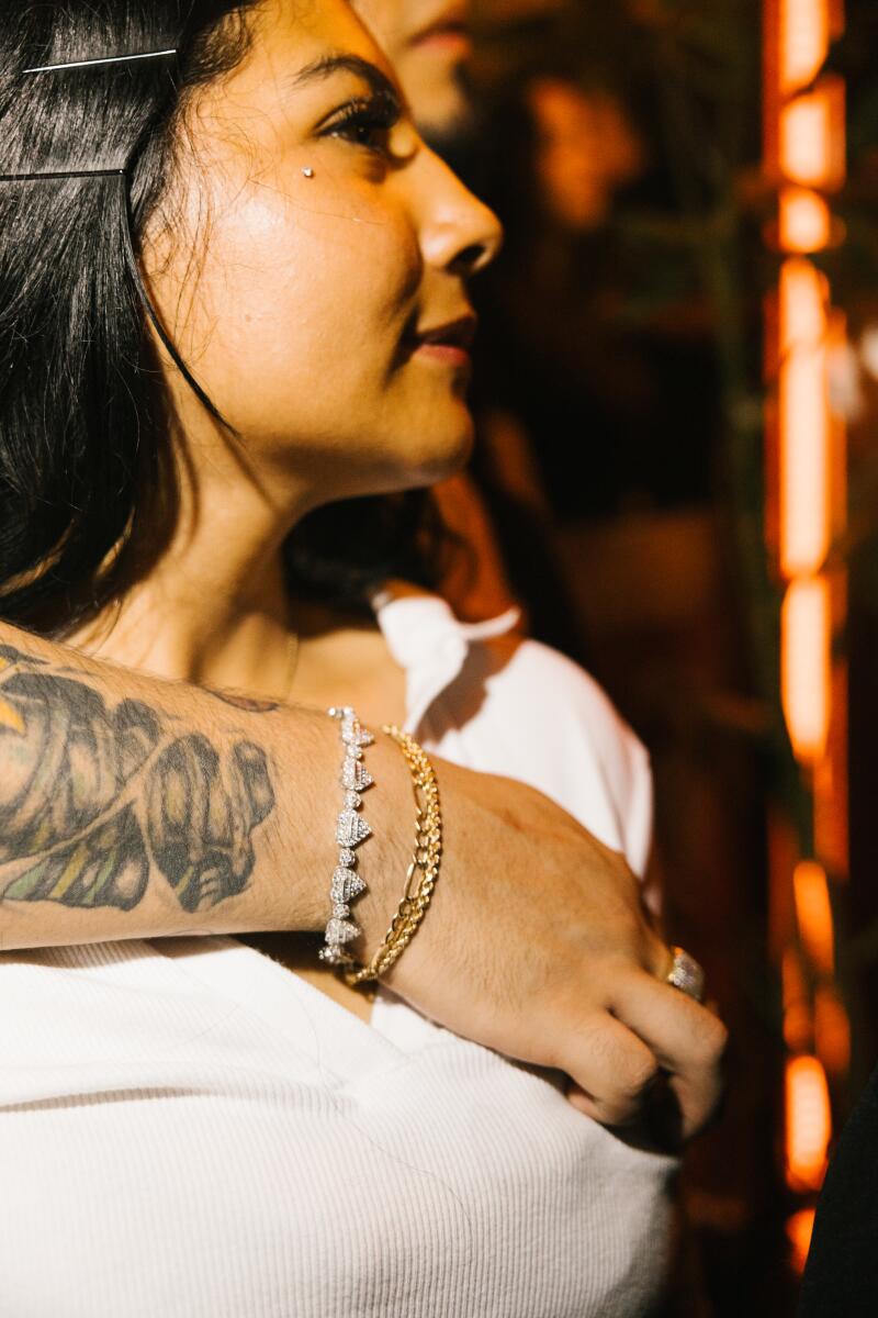 An assemblage subordinate wears a diamond concatenation bracelet