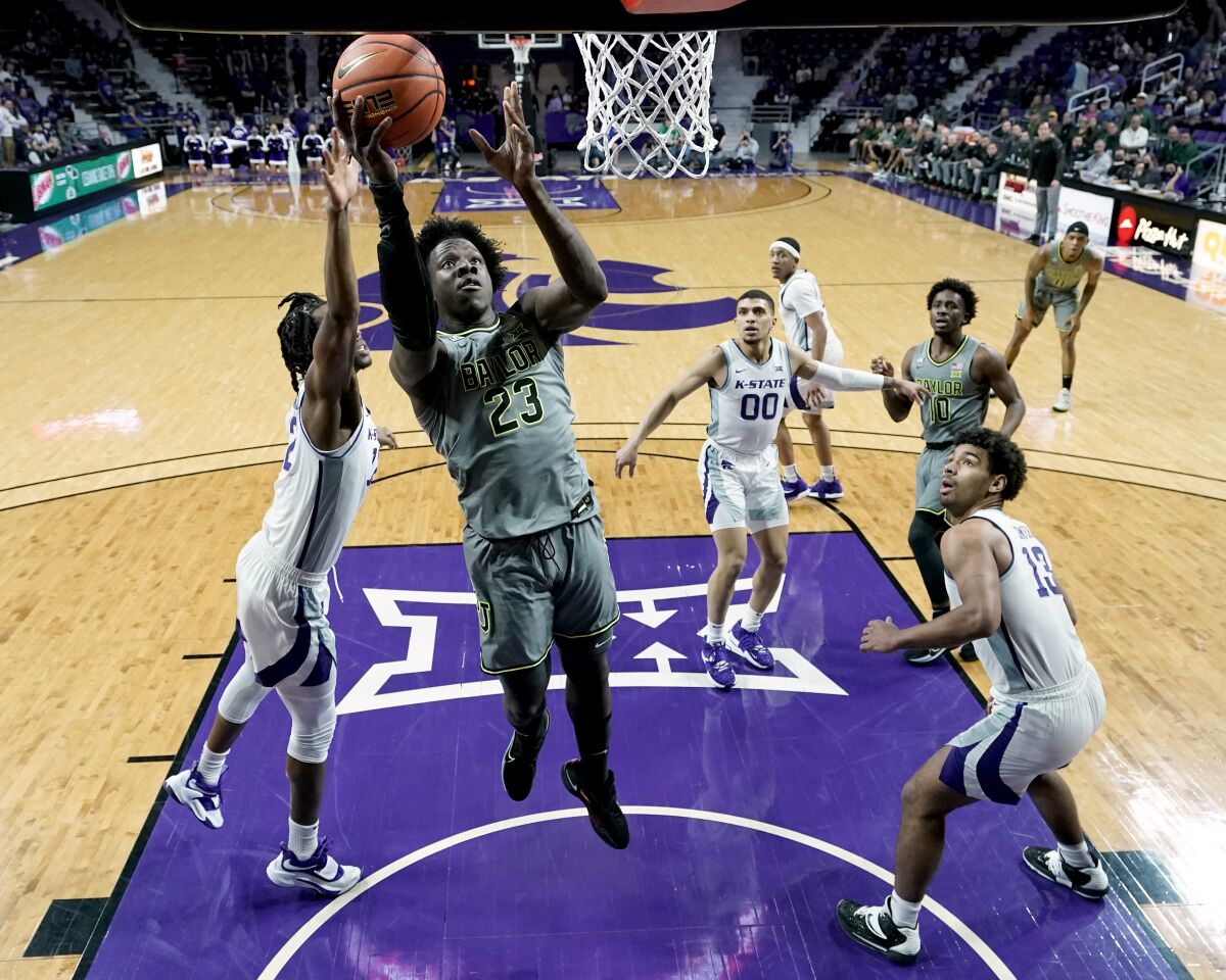 Baylor forward Jonathan Tchamwa Tchatchoua (23) puts up a shot during the first half of an NCAA college basketball game against Kansas State Wednesday, Feb. 9, 2022, in Manhattan, Kan. (AP Photo/Charlie Riedel)