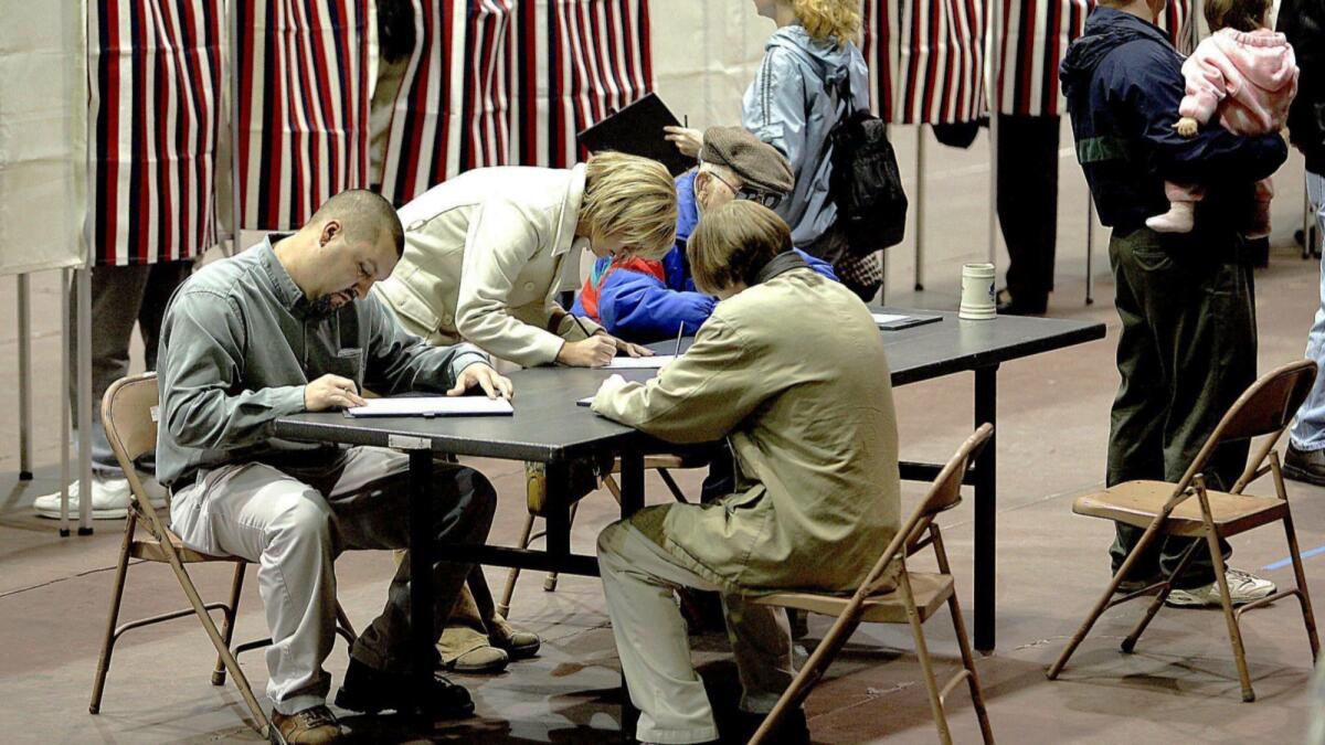 Voters in Dodge City, Kan., cast ballots during the 2004 election.