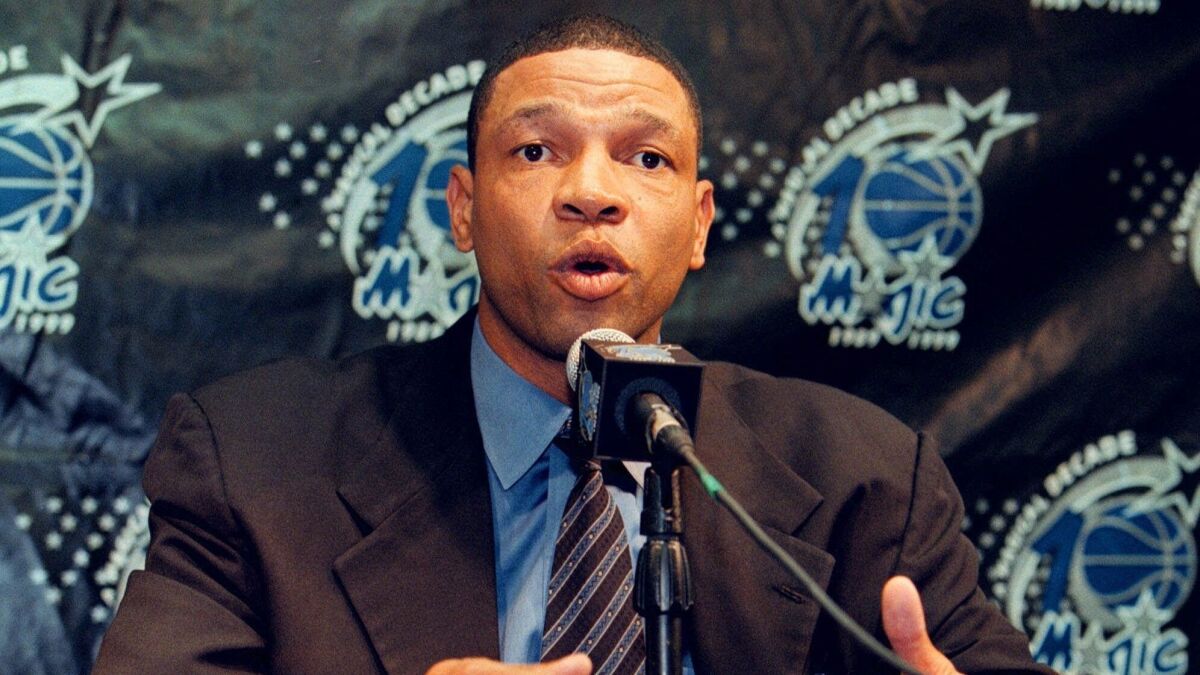 Doc Rivers talks with reporters during a news conference announcing his being named the new head coach of the Orlando Magic in 1999.