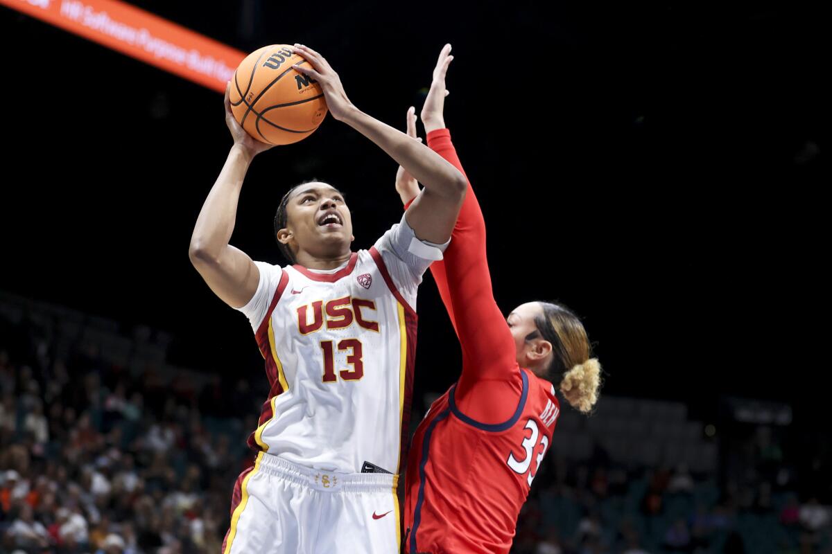 USC center Rayah Marshall (No. 13) shoots over Arizona forward Isis Beh during a Pac-12 tournament game Thursday.