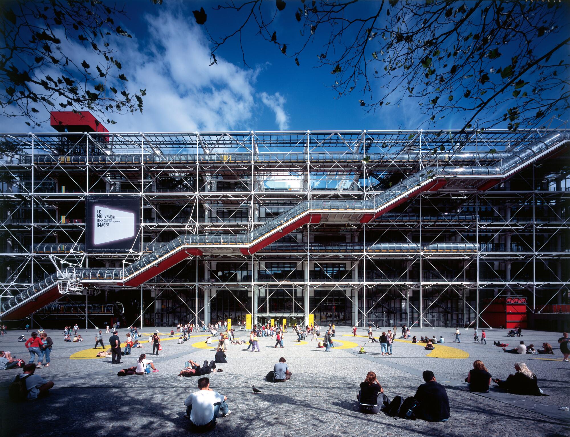 A tube-like structure containing escalators ascends across the facade of the Centre Pompidou