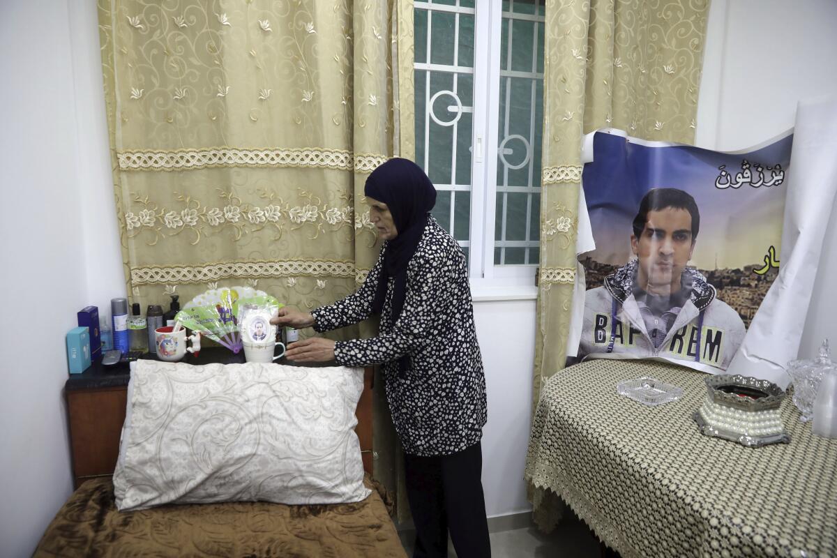 Mother of Iyak Halak, the autistic and unarmed Palestinian killed by Israeli police, arranges his room