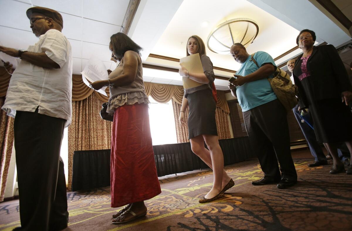 Attendees wait in line at the Cleveland Career Fair in Independence, Ohio, in June.