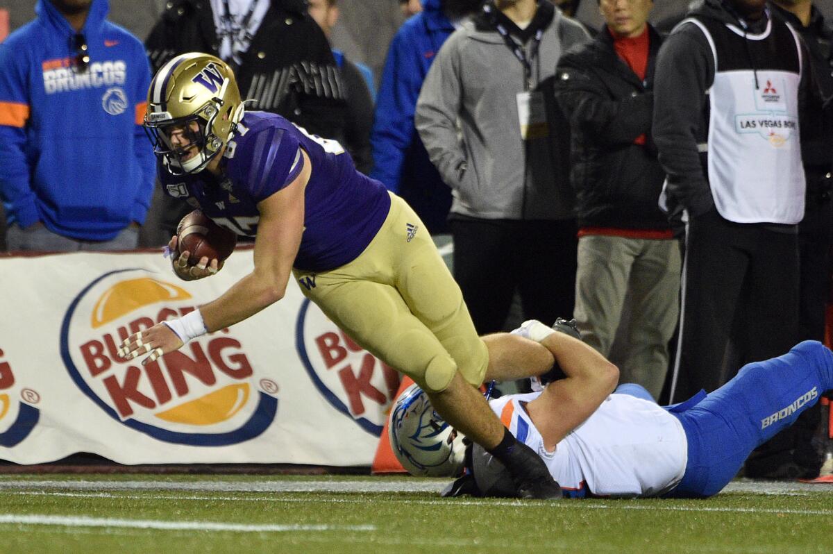 Washington's Cade Otton dives for extra yardage against Boise State during the Las Vegas Bowl on Saturday.