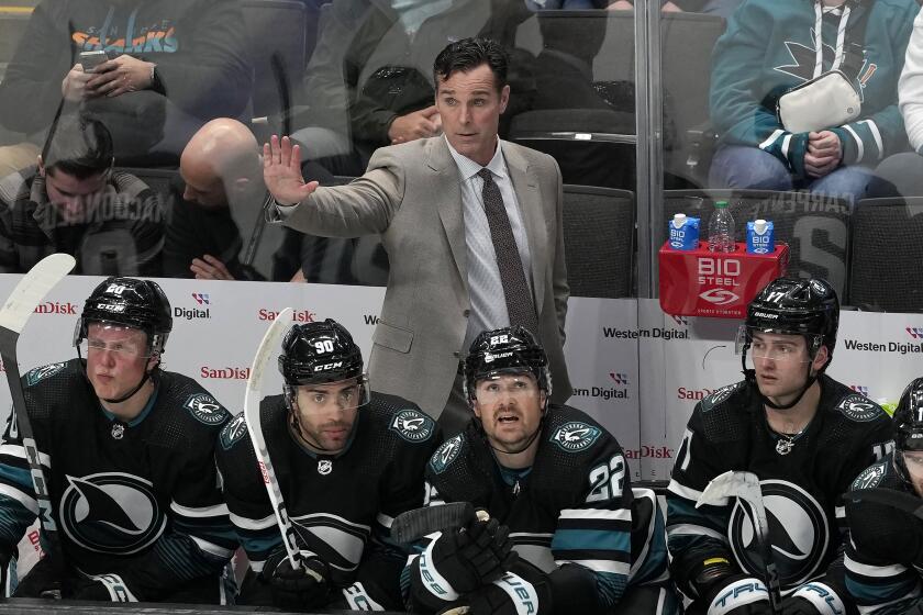 FILE - San Jose Sharks coach David Quinn gestures to players during the third period of the team's NHL hockey game against the Dallas Stars in San Jose, Calif., Tuesday, March 26, 2024. The San Jose Sharks have fired coach David Quinn after two rough seasons as part of a massive rebuilding project. General manager Mike Grier announced the decision on Wednesday, April 24, following a review of the team's season. (AP Photo/Jeff Chiu, File)