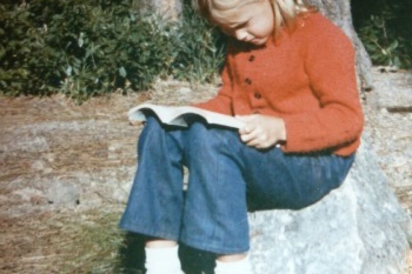 Jessica Gelt reads on a family camping trip.