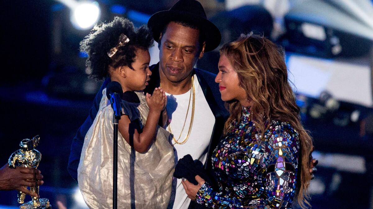 Blue Ivy Carter hit the MTV Video Music Awards stage with father Jay Z after mom Beyonce performed and received the Video Vanguard Award on Sunday.