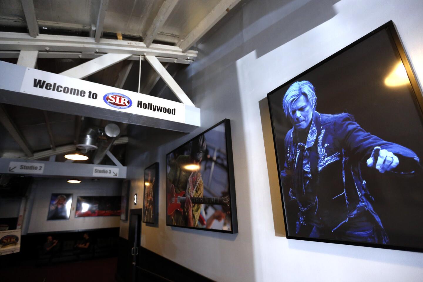 A gallery of photographs, including the late David Bowie, welcomes visitors to Studio Instrument Rentals (SIR) in Los Angeles.