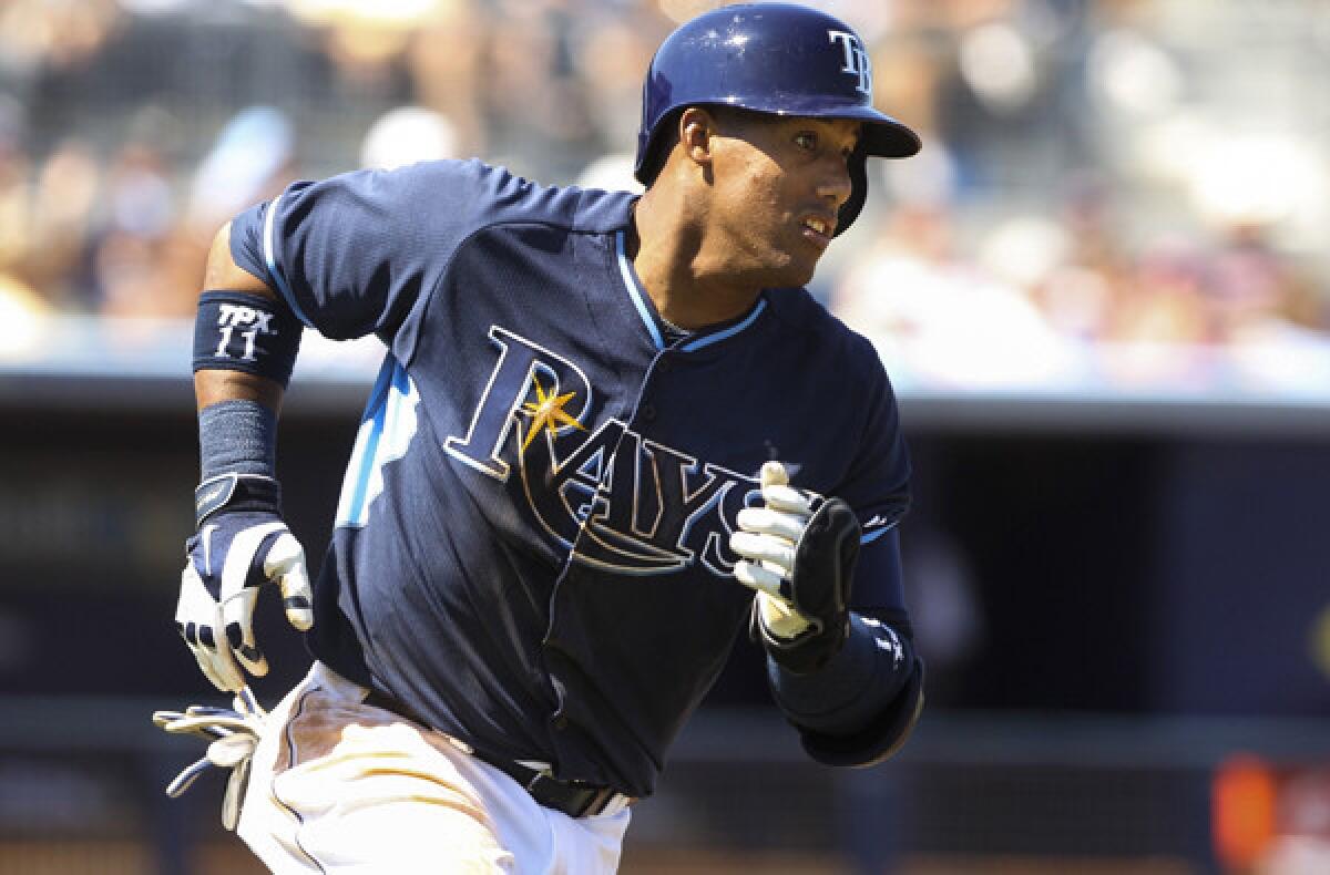 Rays shortstop Yunel Escobar runs to first base after getting a hit against the Minnesota Twins during an exhibition game.