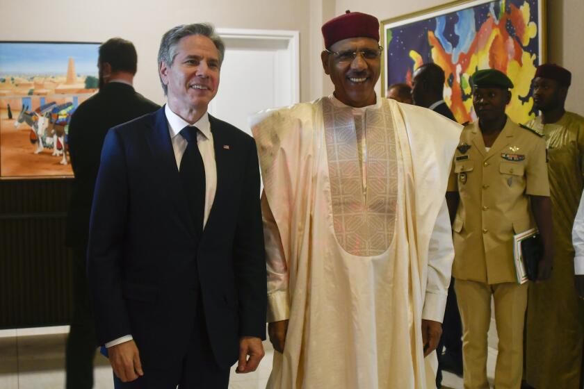 FILE - U..S Secretary of State Antony Blinken, left, poses for a photo with Nigerien President Mohamed Bazoum during their meeting at the presidential palace in Niamey, Niger, March 16, 2023. Supporters of Niger's deposed President Mohamed Bazoum have pleaded with the United States and others for weeks to restore the democratically elected leader to power. Now they're making a simpler plea: Save his life. (Boureima Hama/Pool Photo via AP)